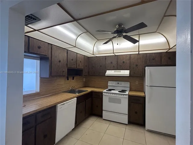 a kitchen with a stove and a refrigerator