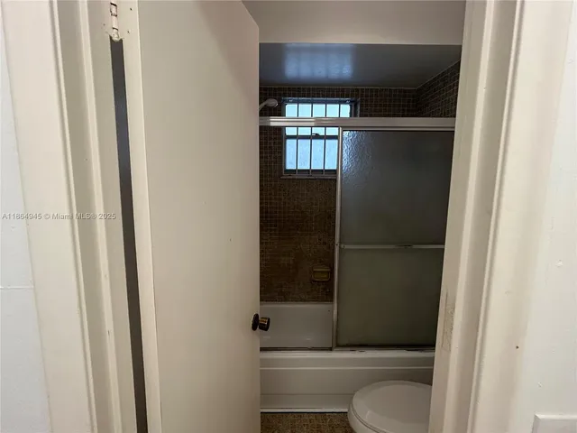 a bathroom with a shower and toilet