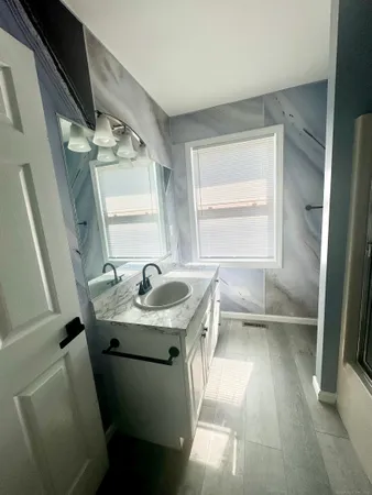 a bathroom with a sink toilet and a mirror