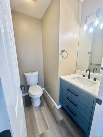 a bathroom with a toilet a sink and mirror