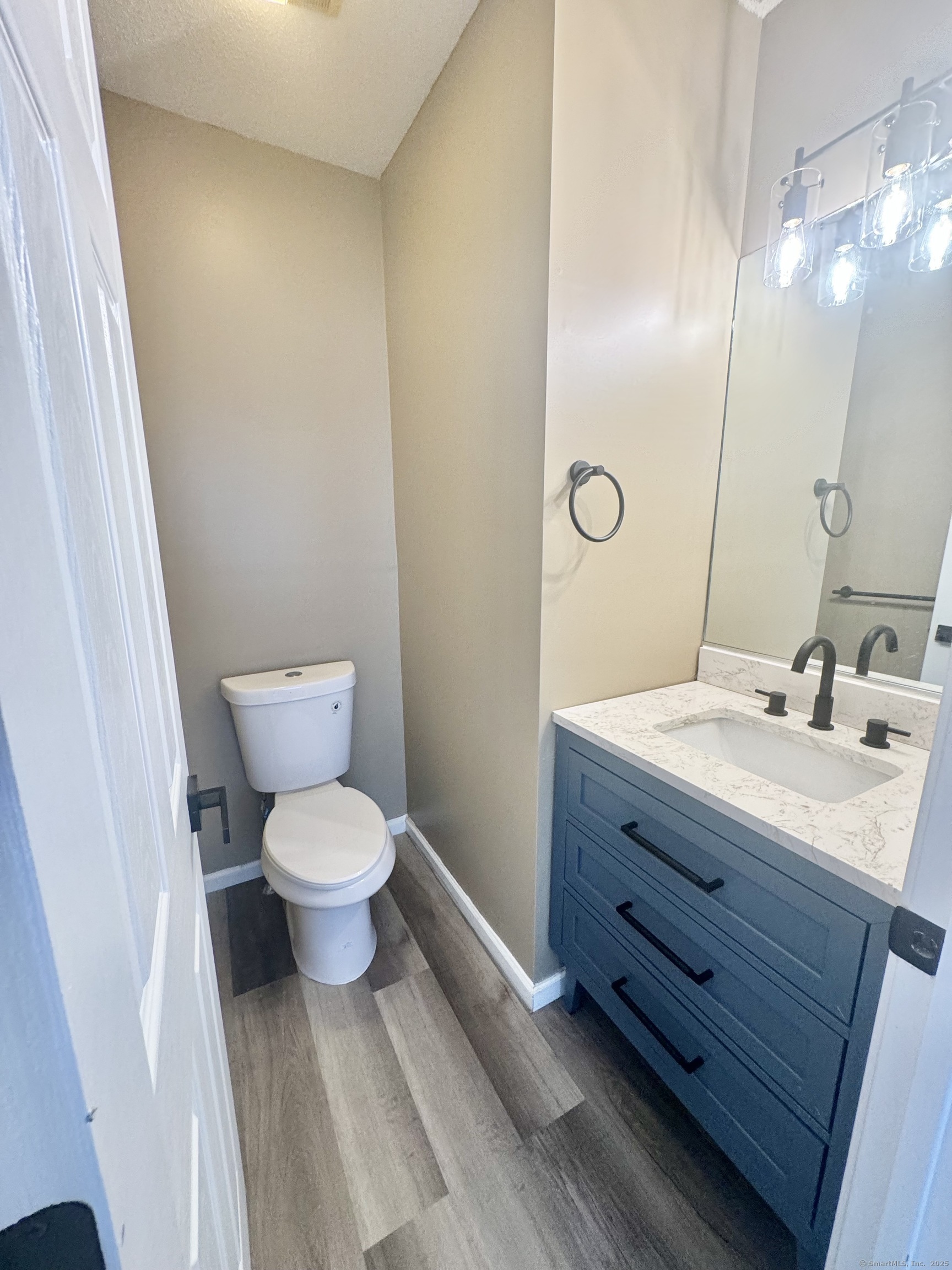 116 Dunbar Lane, Unit 2 Hamden, CT 06514 - Photo 20 of 22 a bathroom with a toilet a sink and mirror