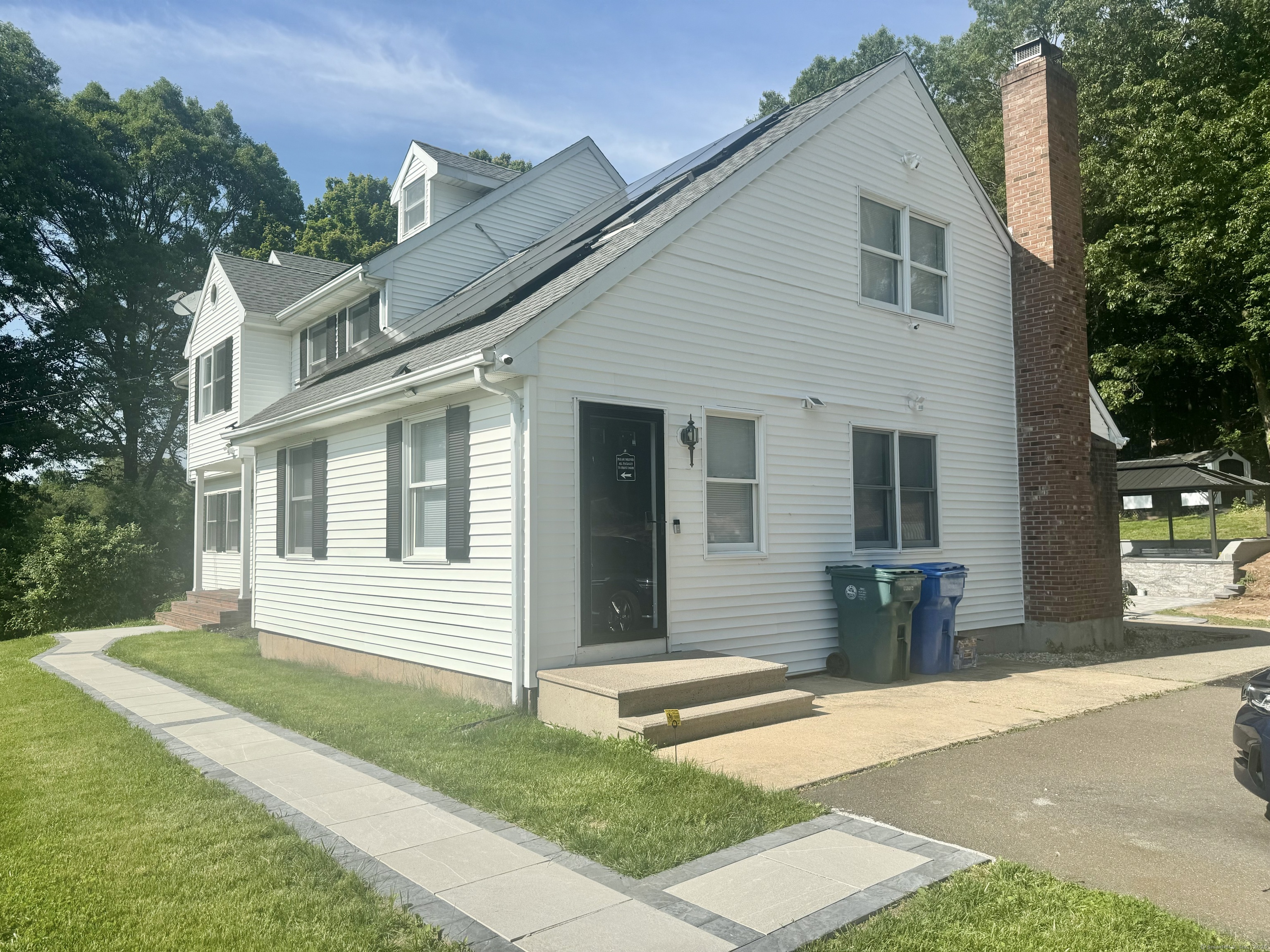 116 Dunbar Lane, Unit 2 Hamden, CT 06514 - Photo 2 of 22 a front view of a house with a yard