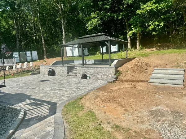 a view of backyard with swimming pool and outdoor seating
