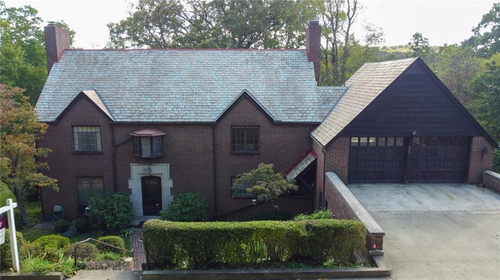 605 Center Street Emlenton, PA 16373 - Photo 2 of 47 a view of a house with brick walls and a yard with plants