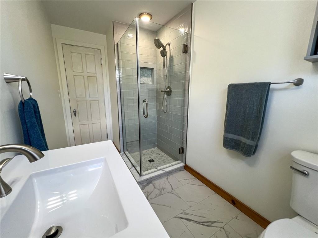 605 Center Street Emlenton, PA 16373 - Photo 22 of 47 a bathroom with a sink a toilet and shower