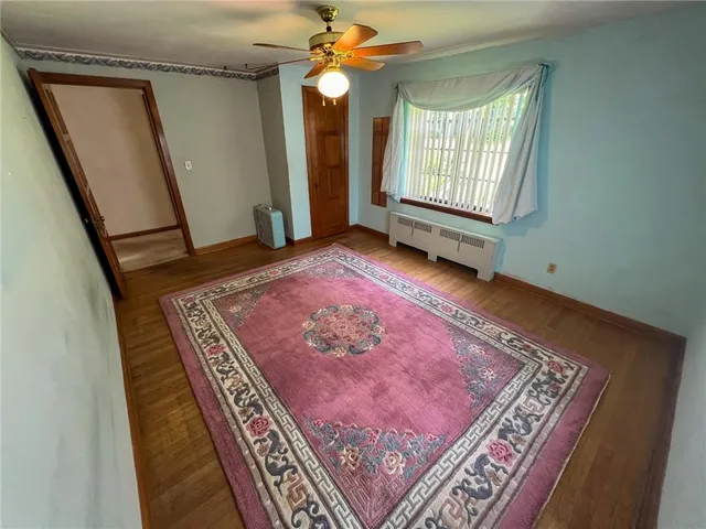 a view of a livingroom with a ceiling fan and window