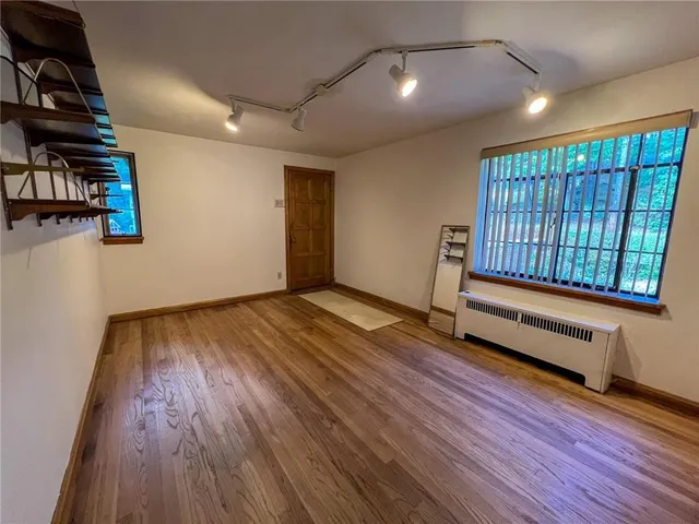 a view of a porch with wooden floor