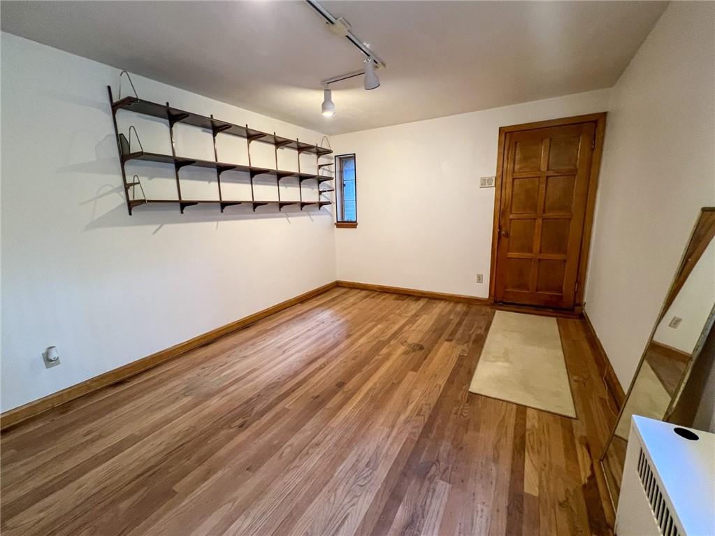 605 Center Street Emlenton, PA 16373 - Photo 28 of 47 an empty room with wooden floor and windows