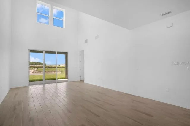 a view of a room with wooden floor and a sink