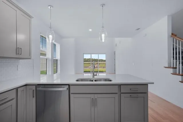 a kitchen with a sink window and cabinets