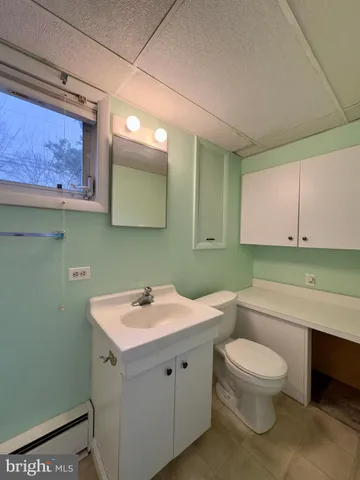 a bathroom with a toilet sink and mirror