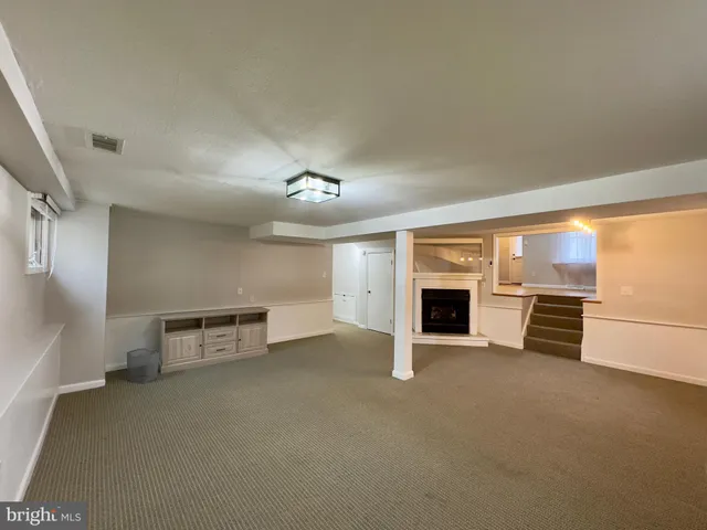 an empty room with furniture and a fireplace