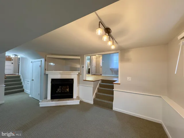 a view of a livingroom with a fireplace and window