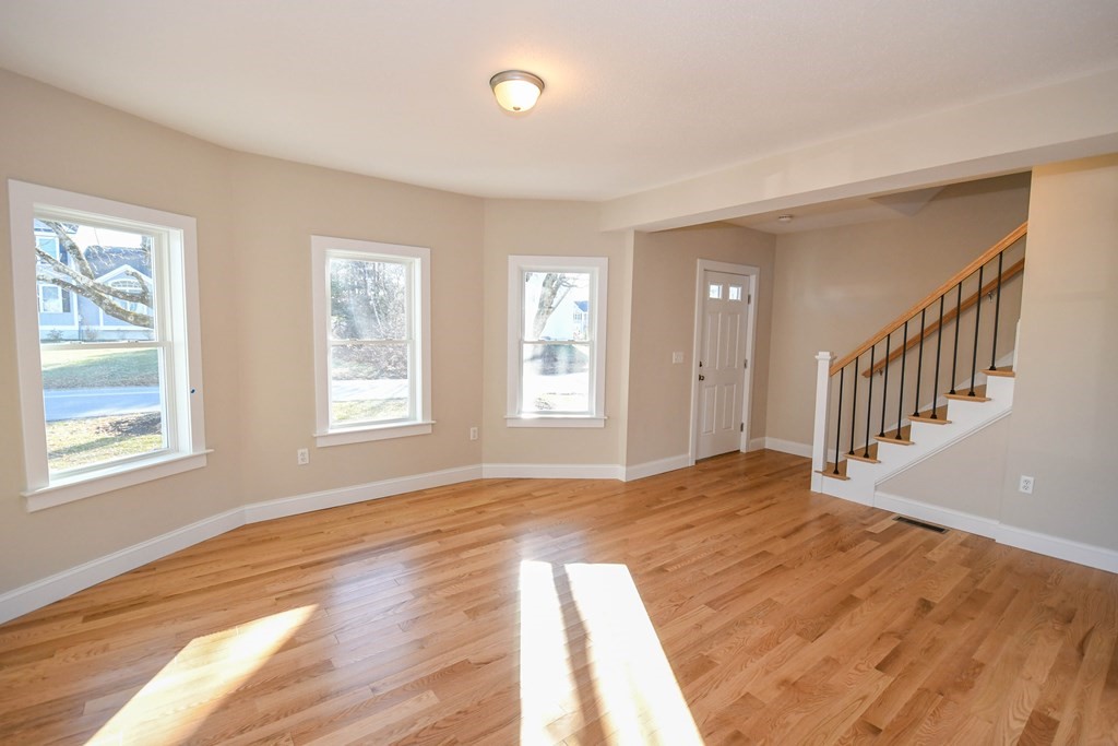 286 Wheeler Road Dracut, MA 01826 - Photo 12 of 32 a view of an empty room with wooden floor and a window