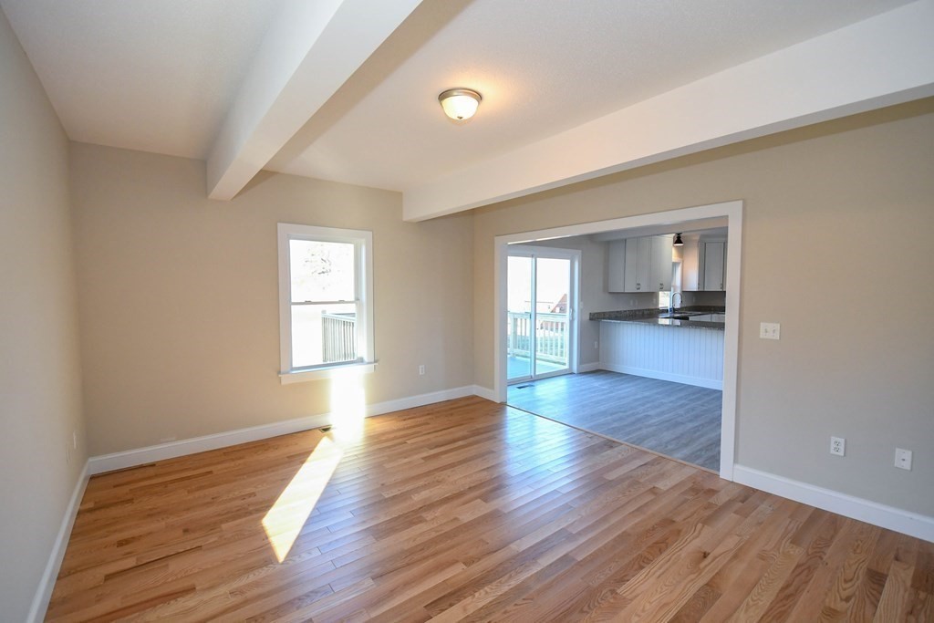 286 Wheeler Road Dracut, MA 01826 - Photo 15 of 32 an empty room with wooden floor and windows
