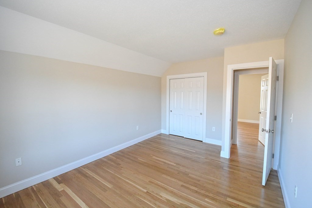 286 Wheeler Road Dracut, MA 01826 - Photo 17 of 32 a view of an empty room with wooden floor and a window