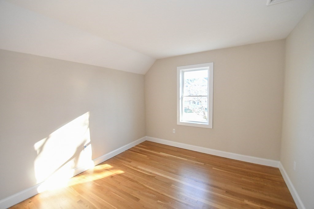 286 Wheeler Road Dracut, MA 01826 - Photo 19 of 32 an empty room with wooden floor and windows