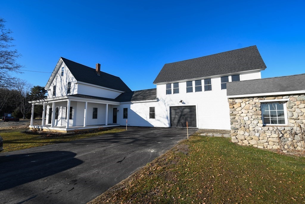 286 Wheeler Road Dracut, MA 01826 - Photo 2 of 32 a front view of a house with a yard