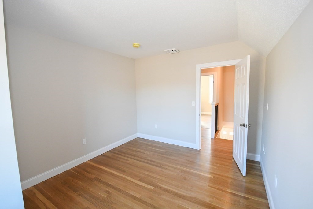 286 Wheeler Road Dracut, MA 01826 - Photo 23 of 32 a view of an empty room with wooden floor