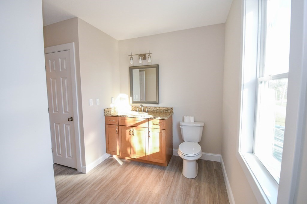 286 Wheeler Road Dracut, MA 01826 - Photo 24 of 32 a bathroom with a toilet and a sink
