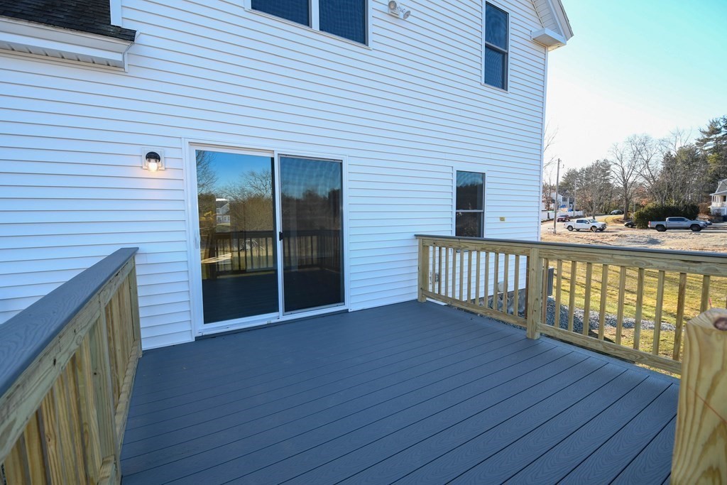 286 Wheeler Road Dracut, MA 01826 - Photo 5 of 32 a view of a deck with wooden floor and fence and a window