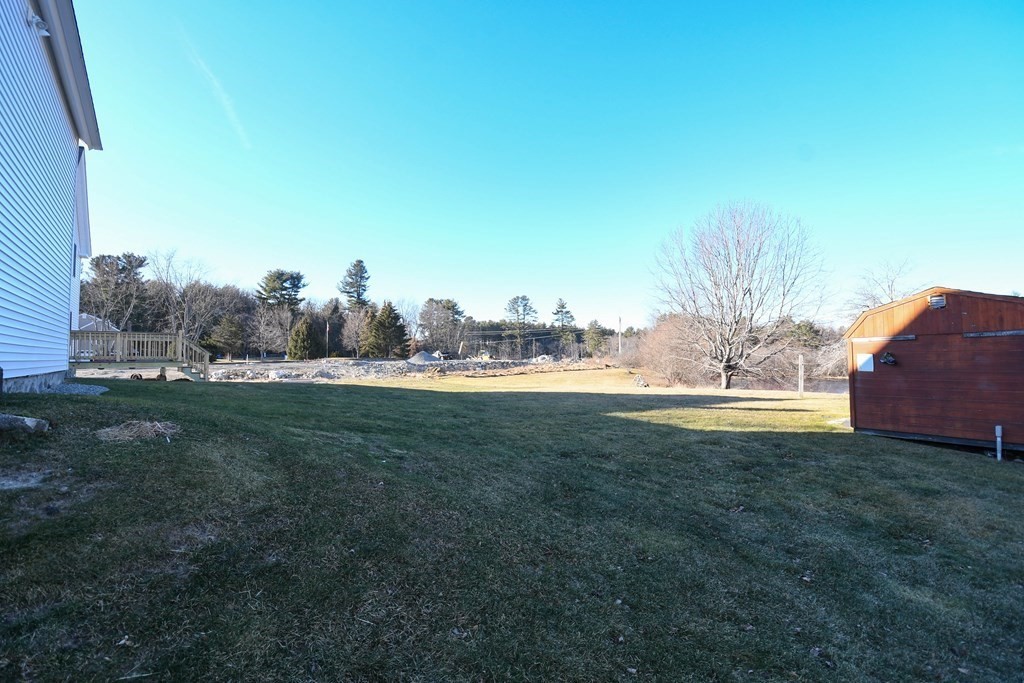 286 Wheeler Road Dracut, MA 01826 - Photo 8 of 32 a view of a green field
