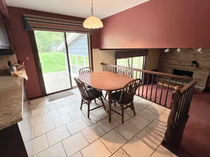 a view of a dining room with furniture wooden floor and chandelier