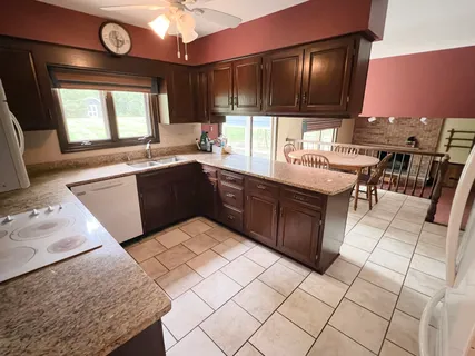 a kitchen with stainless steel appliances granite countertop a sink and a stove