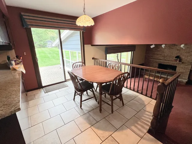 a view of a dining room with furniture wooden floor and chandelier