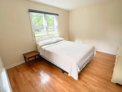 a bed sitting in a bedroom next to a window
