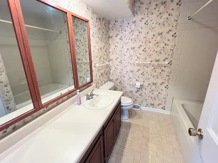 a bathroom with a bathtub and a sink