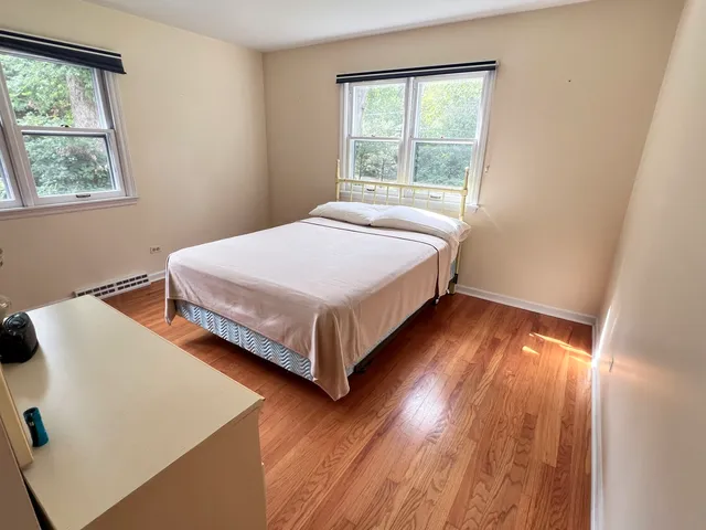a bedroom with a bed and window