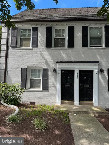 a view of a brick house with a large windows