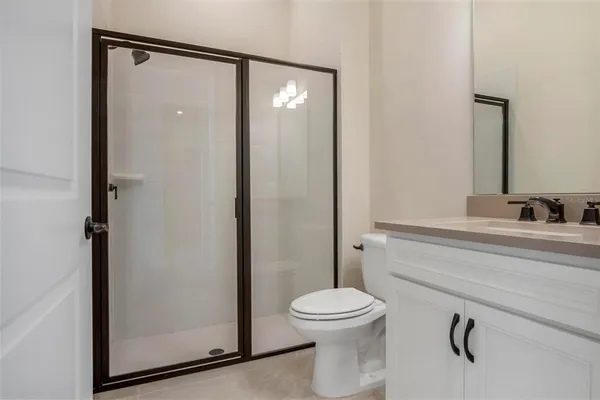 a bathroom with a toilet a sink and shower