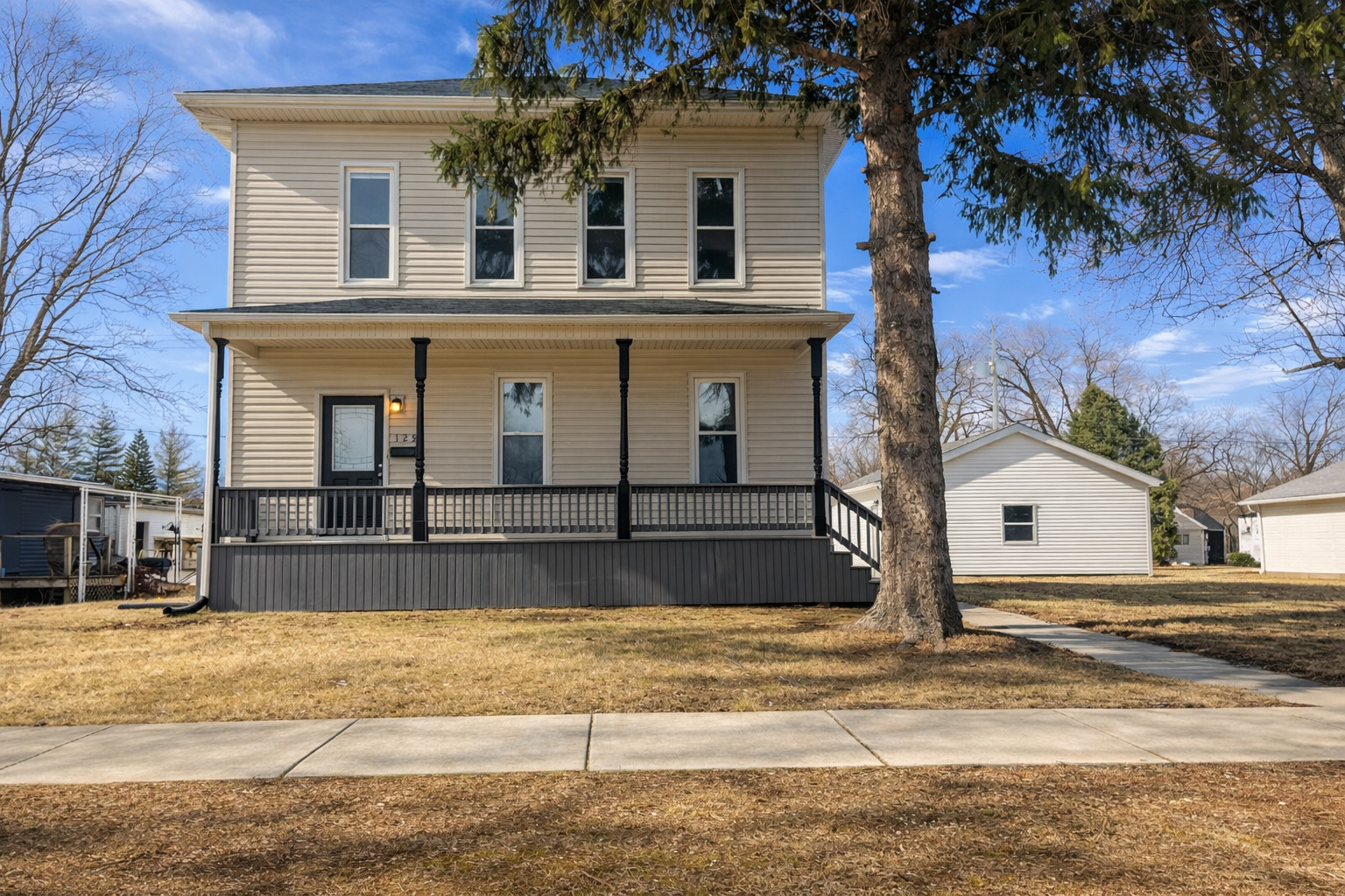 125 South Main Street Clifton, IL 60927 - Photo 1 of 30 a view of a white house with a large tree