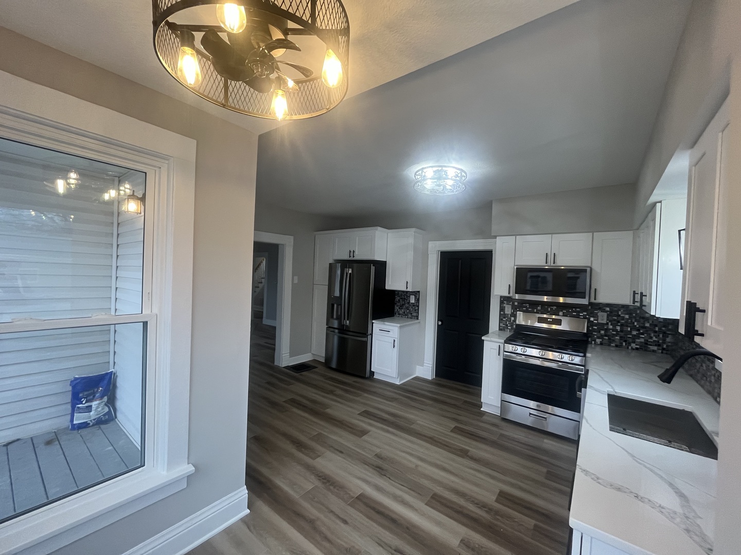 125 South Main Street Clifton, IL 60927 - Photo 13 of 30 a kitchen with stainless steel appliances granite countertop a refrigerator and a stove top oven
