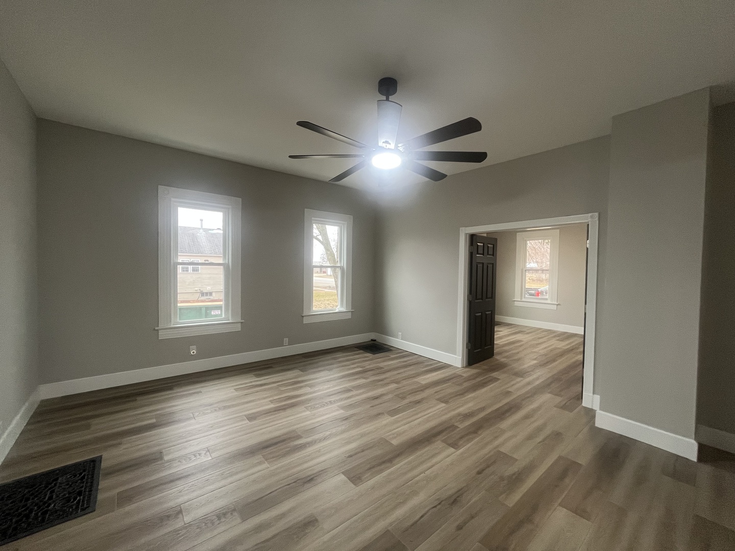 125 South Main Street Clifton, IL 60927 - Photo 7 of 30 a view of an empty room with window and wooden floor
