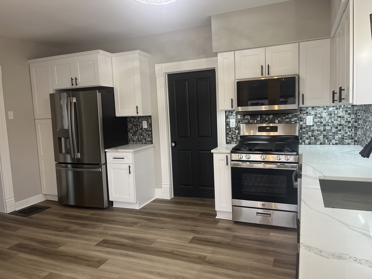125 South Main Street Clifton, IL 60927 - Photo 10 of 30 a kitchen with stainless steel appliances a refrigerator stove and microwave