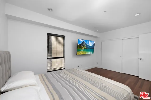 a bedroom with a bed and a tv