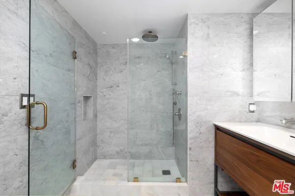 a bathroom with a shower and a sink