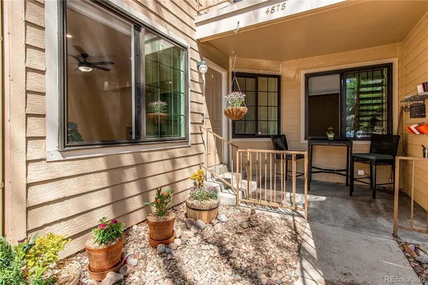 a view of a patio with table and chairs and potted plants