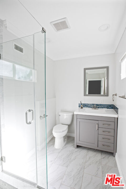 16636 Calneva Drive Encino, CA 91436 - Photo 9 of 19 a bathroom with a granite countertop sink a toilet and a shower