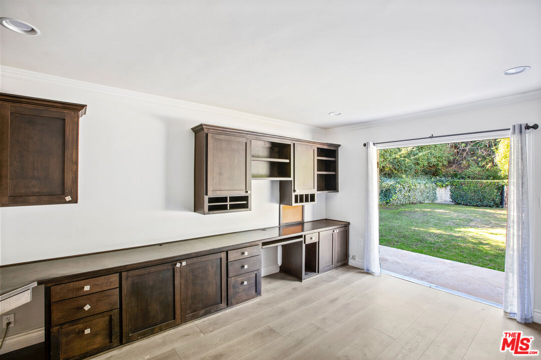 16636 Calneva Drive Encino, CA 91436 - Photo 10 of 19 a kitchen with stainless steel appliances granite countertop a stove and a sink with garden view