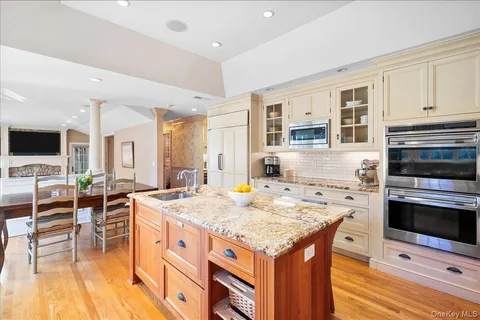 a kitchen that has a stove and a table in it
