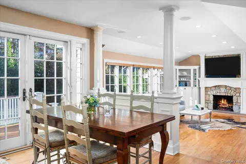 a dining room with furniture window and wooden floor