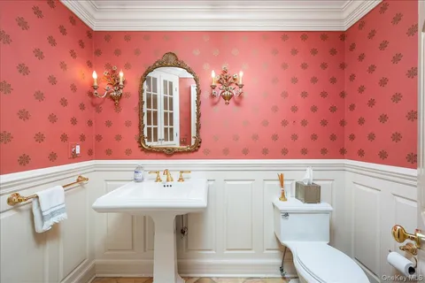 a bathroom with a sink a mirror and a toilet