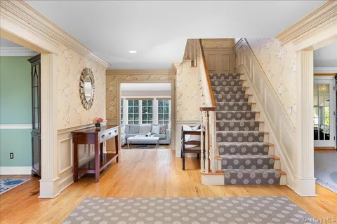 a view of a bedroom with wooden floor and windows