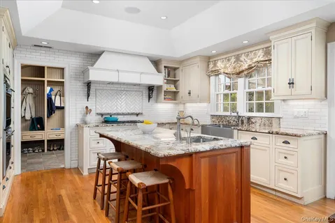 a kitchen with granite countertop a sink stove and cabinets