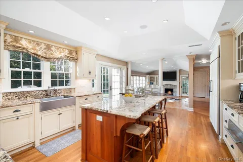 a kitchen with stainless steel appliances granite countertop a stove and a wooden floors