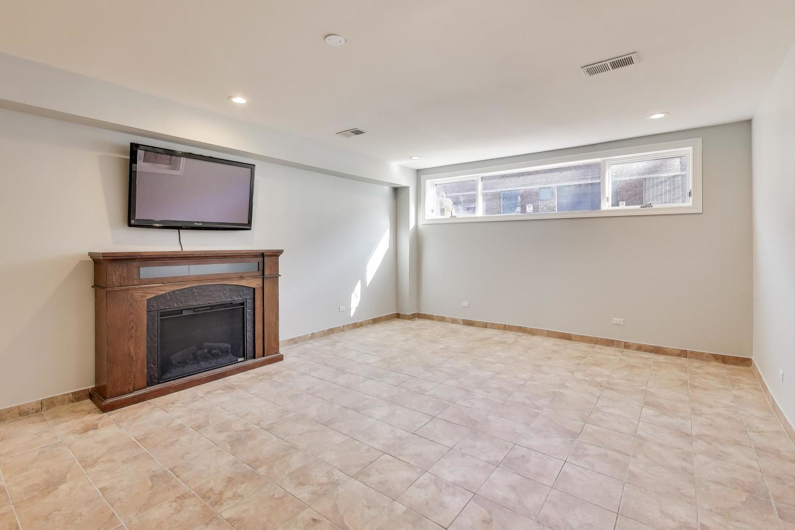 1920 North Springfield Avenue, Unit 1S Chicago, IL 60647 - Photo 25 of 36 a view of empty room with a fireplace